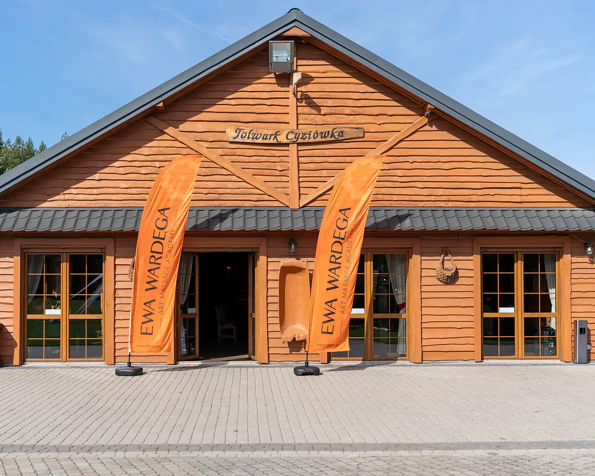 The entrance to Folwark Cyziówka with Ewa Wardęga Art Massage Academy flags